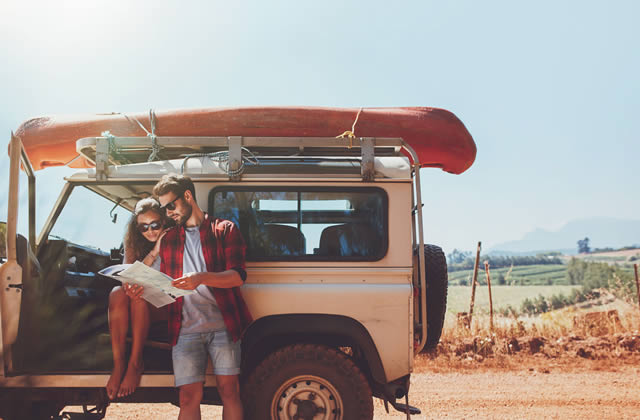 Importance of Trust - Vacationing couple verifying map directions