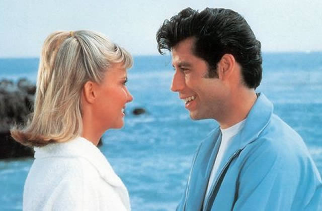 Couple smiling at each other at seaside