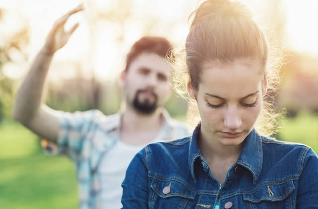 Types of Men to Avoid - Sad looking lady with annoyed guy in the background Types of Men to Avoid - Sad looking lady with annoyed guy in the background