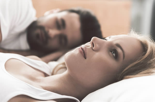 Types of Men to Avoid - Worried lady lying awake in bed with partner sleeping Types of Men to Avoid - Worried lady lying awake in bed with partner sleeping