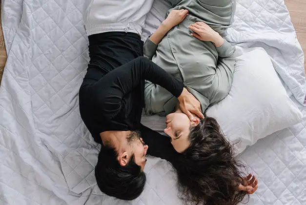 Compliments Men Can't Resist-Couple lying down gazing into each other's eyes Compliments Men Can't Resist-Couple lying down gazing into each other's eyes