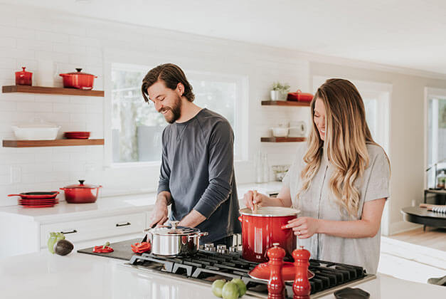 Compliments for Men-Happy couple cooking together in the kitchen Compliments for Men-Happy couple cooking together in the kitchen