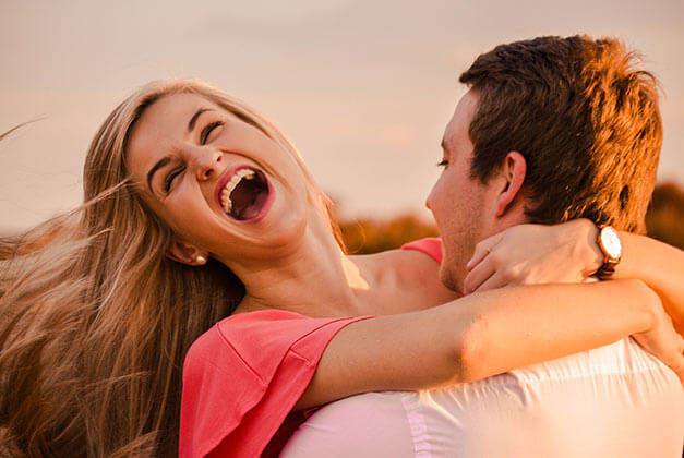 Compliments to Melt His Heart-Happy lady laughing in her guy's embrace Compliments to Melt His Heart-Happy lady laughing in her guy's embrace