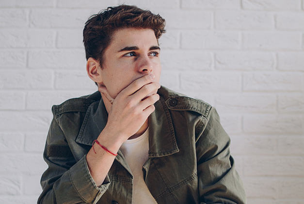 Questions to Ask Before Getting Back Together With An Ex - Young man looking away while lost in thoughts Questions to Ask Before Getting Back Together With An Ex - Young man looking away while lost in thoughts