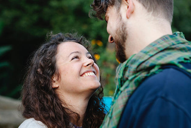 What Does Being in Love And Loving Someone Really Mean? - Happy lady smiling while looking up at her guy What Does Being in Love And Loving Someone Really Mean? - Happy lady smiling while looking up at her guy