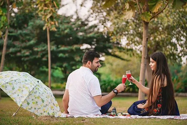 How To Make Him Feel Special - Lady and man having surprise picnic in the park
