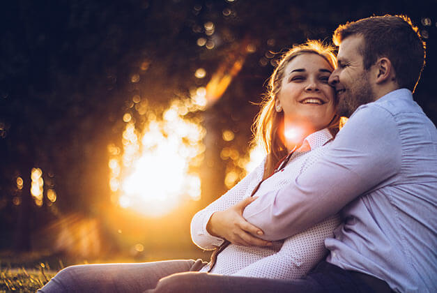 How To Make Your Man Feel Needed - Happy couple in warm embrace outdoors