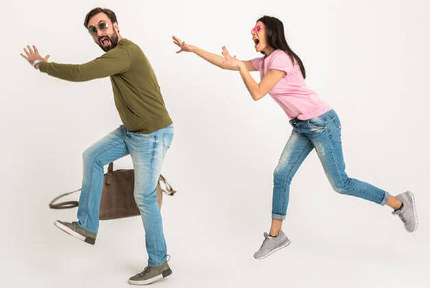 Reasons Why Men Pull Away - Man running away from wife with bag Reasons Why Men Pull Away - Man running away from wife with bag