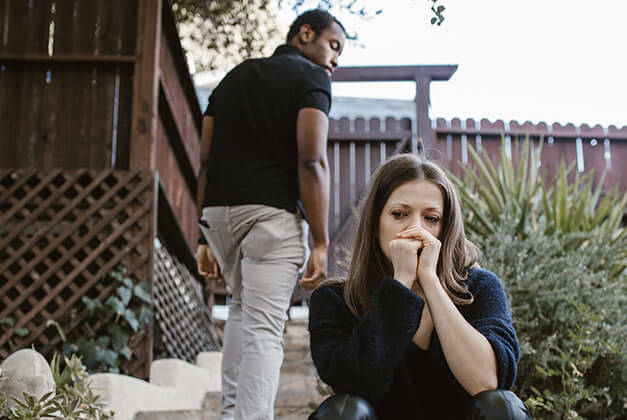 Reasons Why Men Pull Away - Man walking away from sad looking woman Reasons Why Men Pull Away - Man walking away from sad looking woman