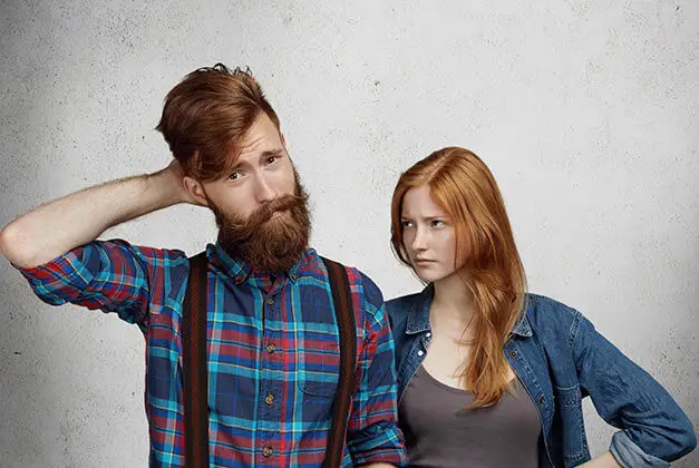 Why Men Pull Away - Confused bearded man with demanding girlfriend looking Why Men Pull Away - Confused bearded man with demanding girlfriend looking
