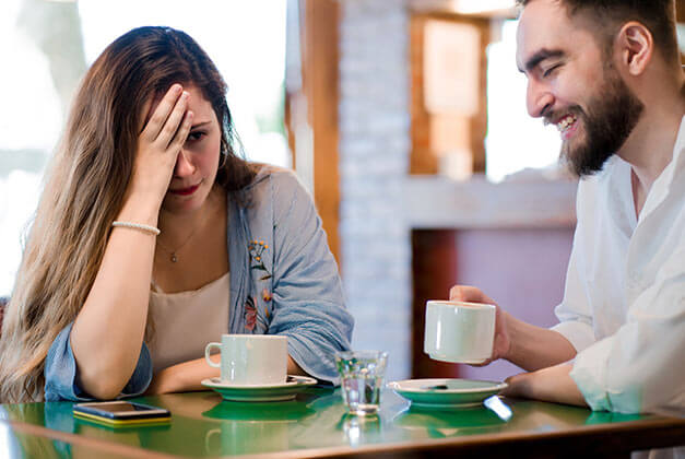 How to Save a Relationship - Woman getting bored with date in coffee shop