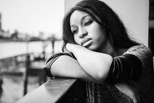 How to Walk Away When He Doesn't Love You Back - Sad young lady alone on balcony contemplating something