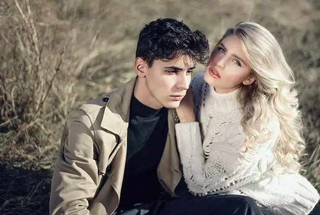 I Love Him But He Doesn't Love Me - Young couple in outdoors with guy looking sadly away while lady holding his shoulder