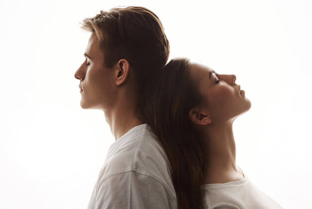 Loving a Guy Who Doesn't Love You - Young couple with head resting against each other while in deep thoughts