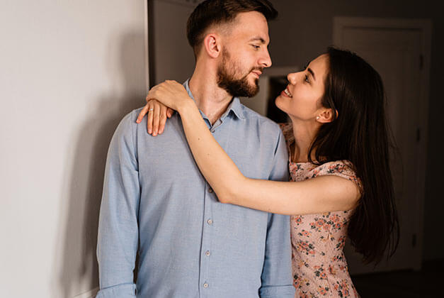 Effectively Communicate in a Relationship With a Man - Smiling young lady embracing husband Effectively Communicate in a Relationship With a Man - Smiling young lady embracing husband
