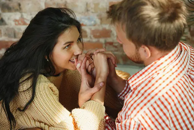 How to Understand and Communicate With Men - Smiling young lady expectantly looking at her husband How to Understand and Communicate With Men - Smiling young lady expectantly looking at her husband